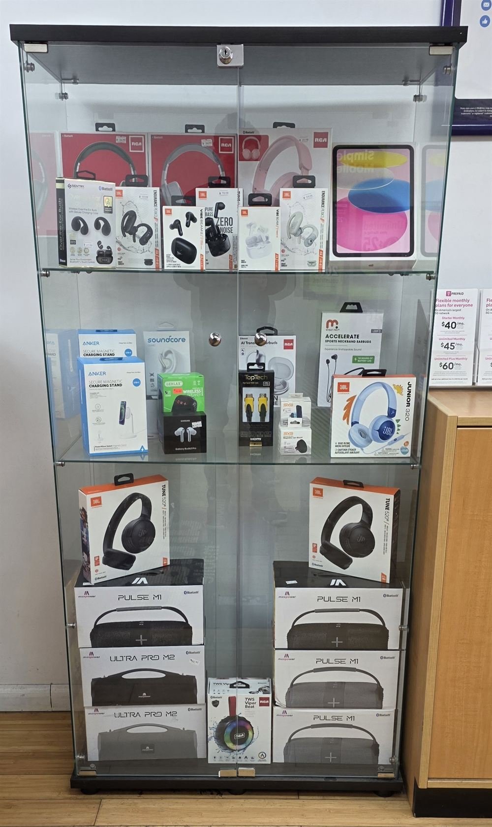 Accessories case at BK Wireless with headphones, earbuds, chargers, and speakers